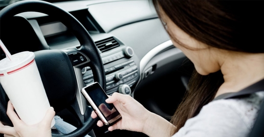 teen driver looking at phone